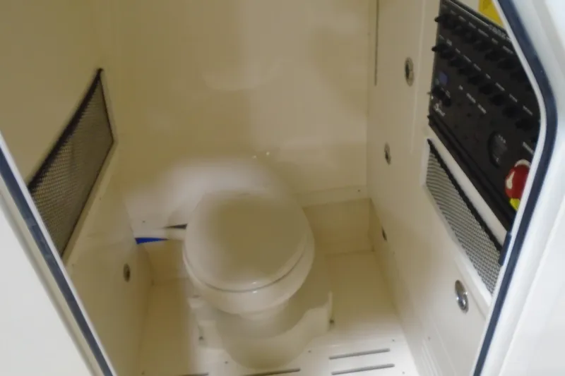 Slide: The Image of 2026 Scout 240 XSF boat interior with toilet and control panel. - 47