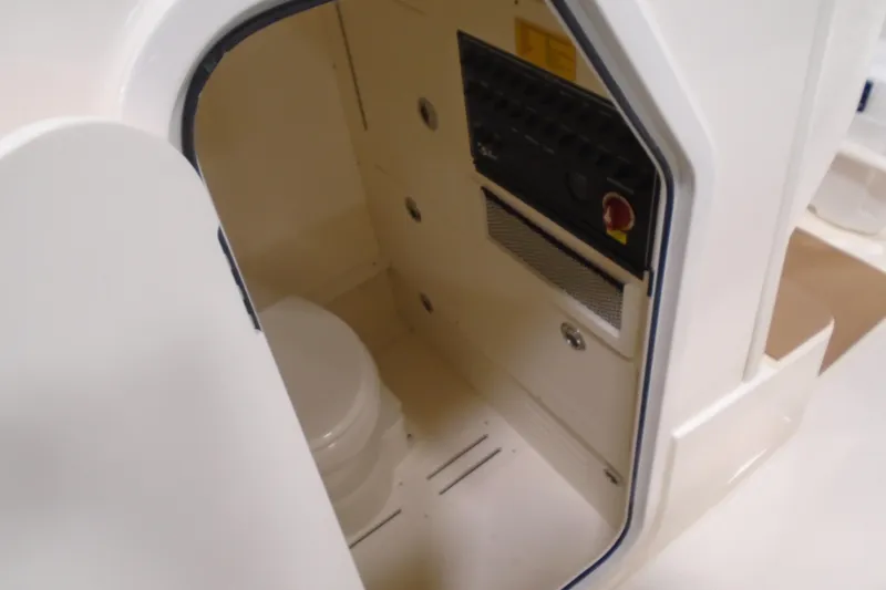 Slide: The Image of Interior view of 2026 Scout 240 XSF boat's compact bathroom area. - 48