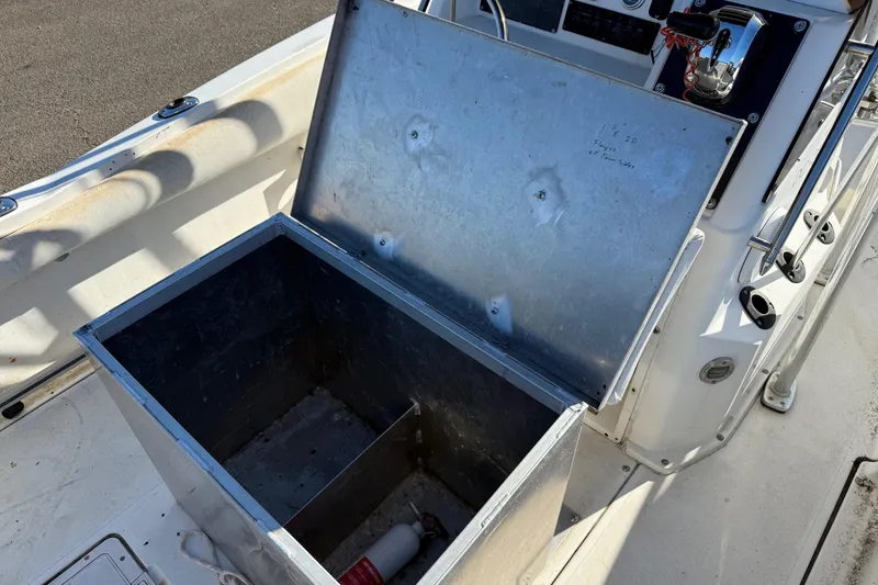 Slide: The Image of Open storage compartment on a 1990 Larson DC-204 boat deck. - 12