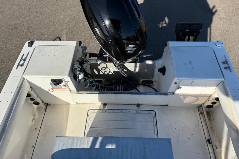 Slide: The Image of 1990 Larson DC-204 boat interior with motor, viewed from above. - 13