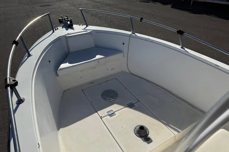 Slide: The Image of 1990 Larson DC-204 boat interior with seating and storage compartments. - 17