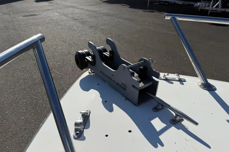 Slide: The Image of 1990 Larson DC-204 boat anchor holder on deck, featuring metal railings and clear sky. - 19