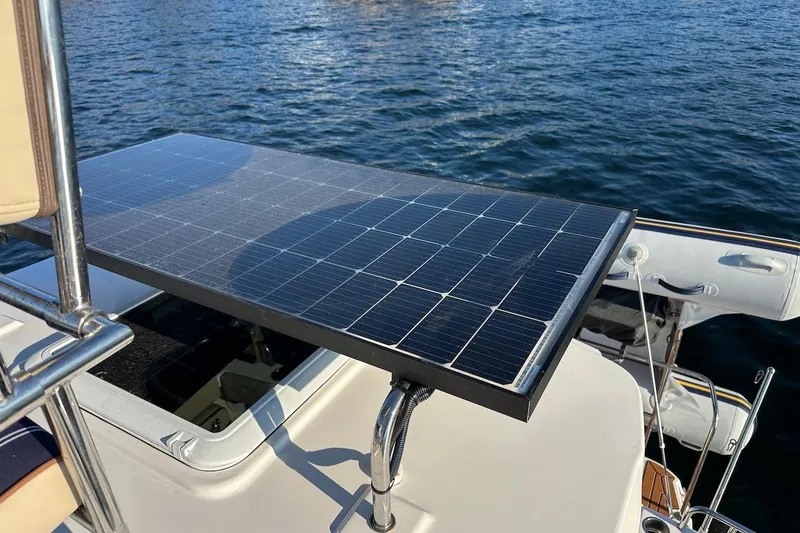 Slide: The Image of 2025 Ranger Tugs R-29 CB with solar panel on deck, floating on water. - 21