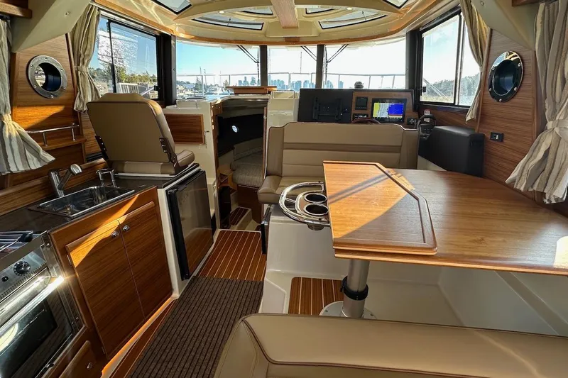 Slide: The Image of Luxurious interior of 2025 Ranger Tugs R-29 CB with modern amenities and wood finishes. - 24