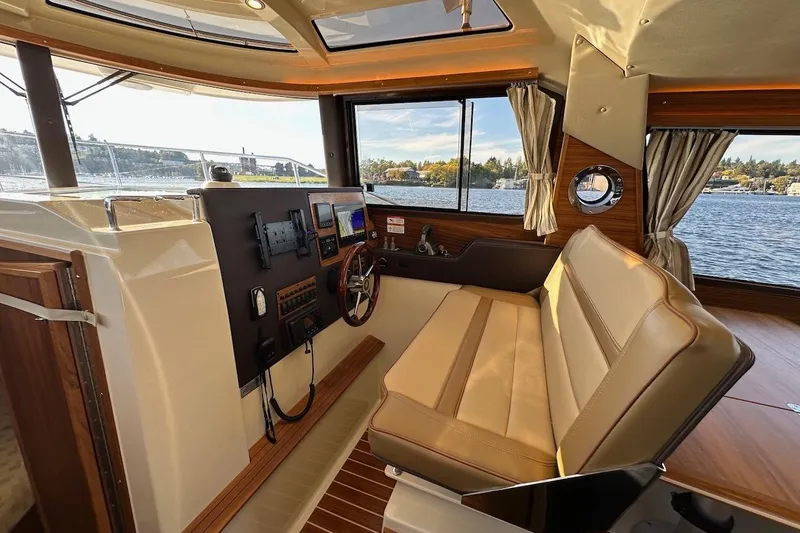 Slide: The Image of Interior of 2025 Ranger Tugs R-29 CB boat with helm and seating area. - 27