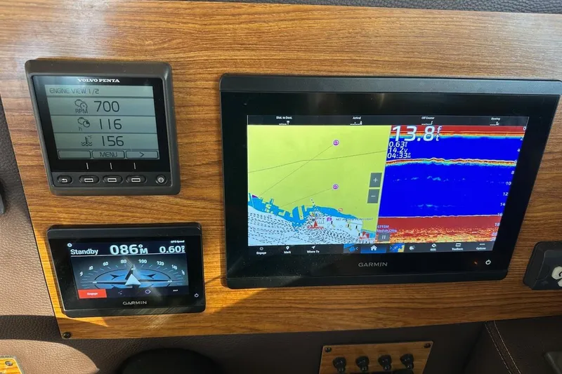 Slide: The Image of 2025 Ranger Tugs R-29 CB dashboard with Garmin navigation and Volvo Penta engine display. - 30