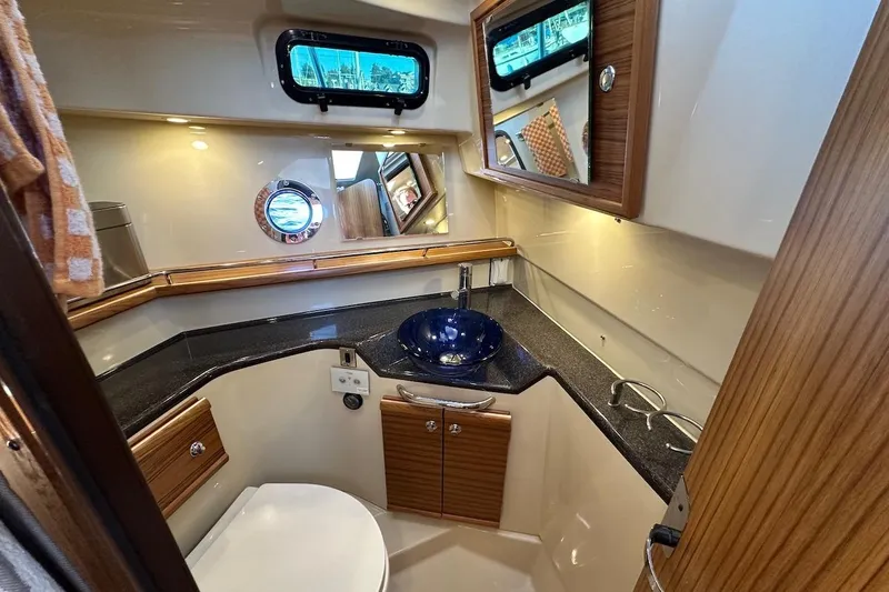 Slide: The Image of Luxurious 2025 Ranger Tugs R-29 CB bathroom with modern fixtures and elegant wood accents. - 39