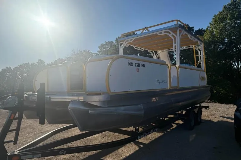 Slide: The Image of 2022 Aloha Pontoon Tropical 260/W on trailer under bright sunlight. - 3