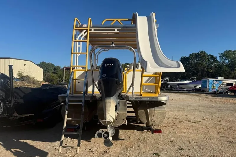 Slide: The Image of 2022 Aloha Pontoon Tropical 260/W with slide and ladder, parked outdoors. - 4