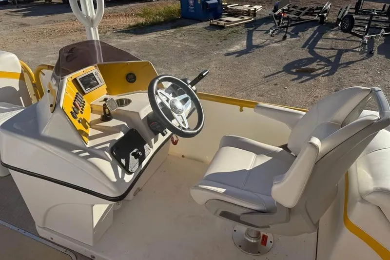 Slide: The Image of 2022 Aloha Pontoon Tropical 260/W helm with steering wheel and captain's chair. - 7