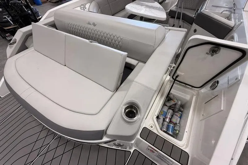 Slide: The Image of 2023 Sea Ray SLX 310 boat interior with seating and storage compartment. - 10