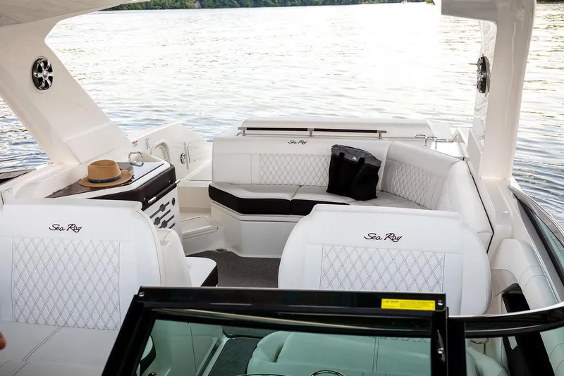 Slide: The Image of 2023 Sea Ray SLX 310 interior with white seating, sink, and non-slip flooring. - 11