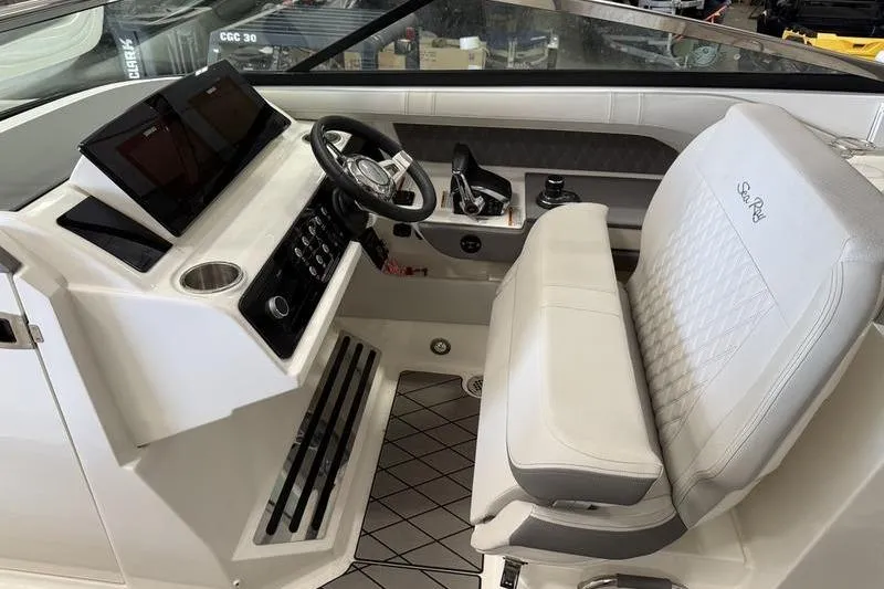 Slide: The Image of 2023 Sea Ray SLX 310 helm with modern controls and luxurious seating. - 19