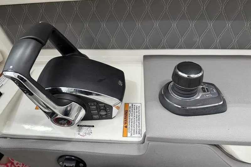 Slide: The Image of 2023 Sea Ray SLX 310 boat controls with joystick and throttle lever. - 22