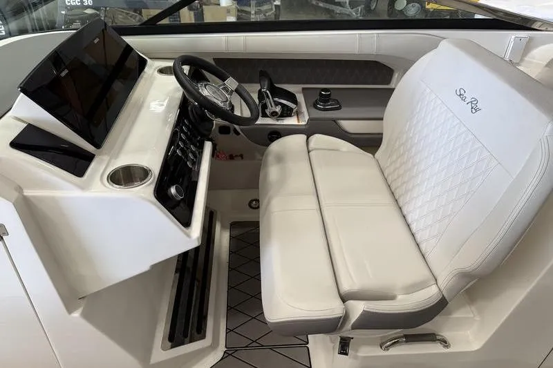 Slide: The Image of 2023 Sea Ray SLX 310 helm with modern controls and luxurious seating. - 23