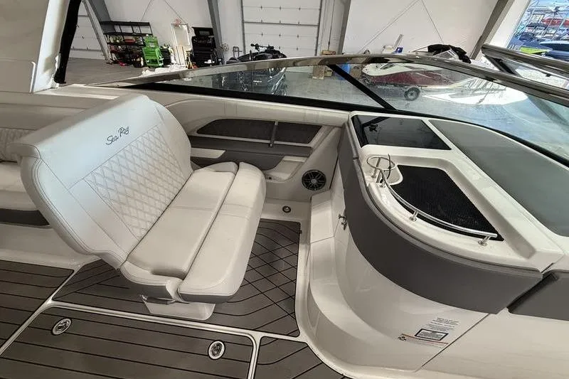 Slide: The Image of 2023 Sea Ray SLX 310 boat interior with white seating and sleek design. - 24