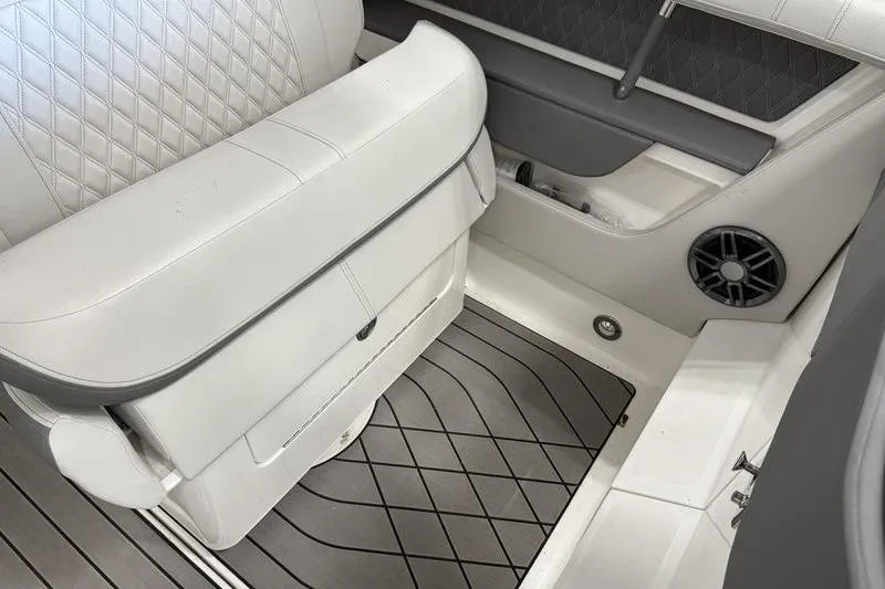 Slide: The Image of 2023 Sea Ray SLX 310 interior with white seating and gray flooring. - 25