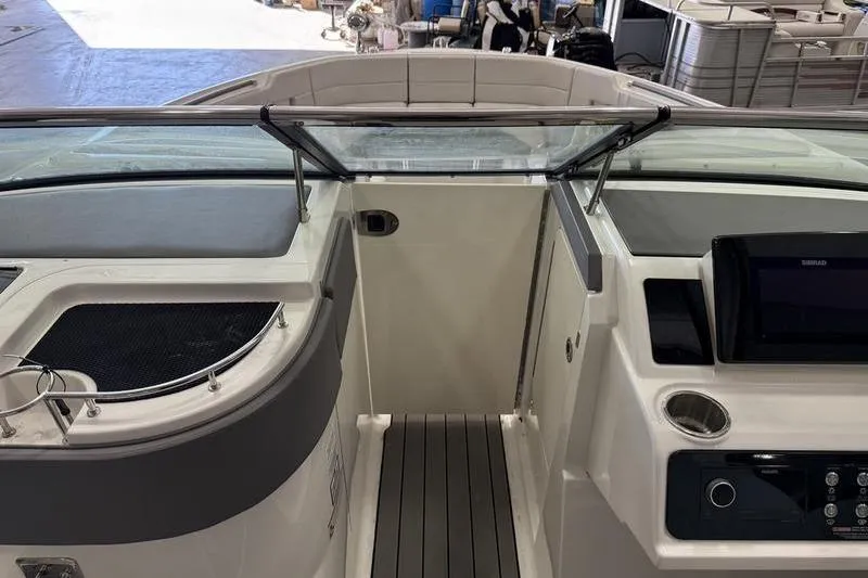 Slide: The Image of 2023 Sea Ray SLX 310 boat interior with modern dashboard and seating area. - 28