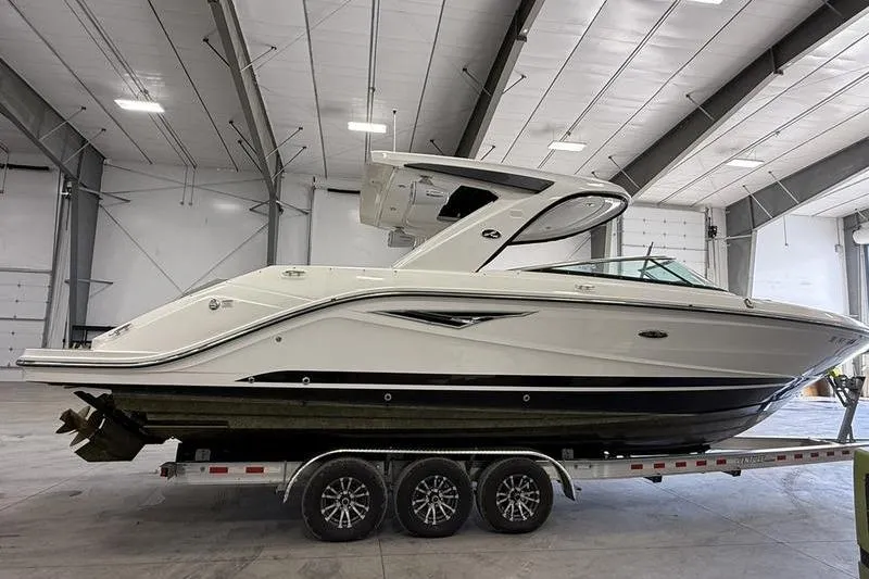 Slide: The Image of 2023 Sea Ray SLX 310 boat on trailer in indoor storage facility. - 3