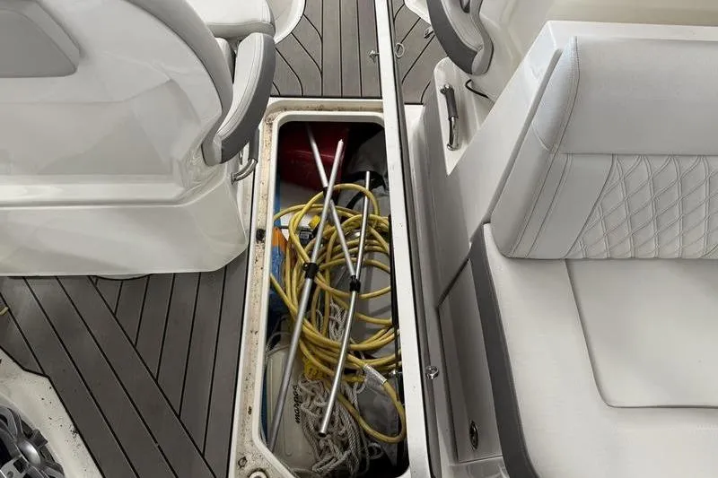 Slide: The Image of 2023 Sea Ray SLX 310 boat interior storage with equipment and seating. - 34