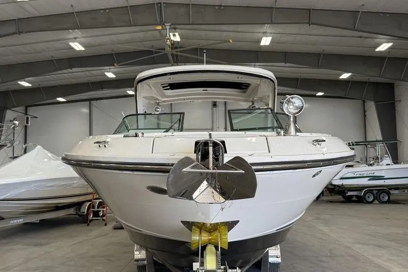Slide: The Image of 2023 Sea Ray SLX 310 boat in a spacious indoor storage facility. - 4