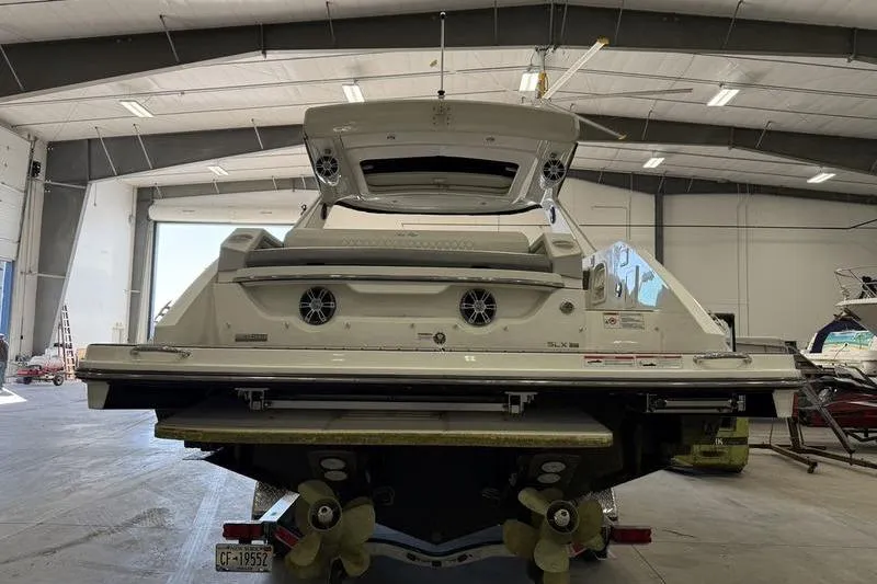 Slide: The Image of 2023 Sea Ray SLX 310 boat in a spacious indoor storage facility. - 5