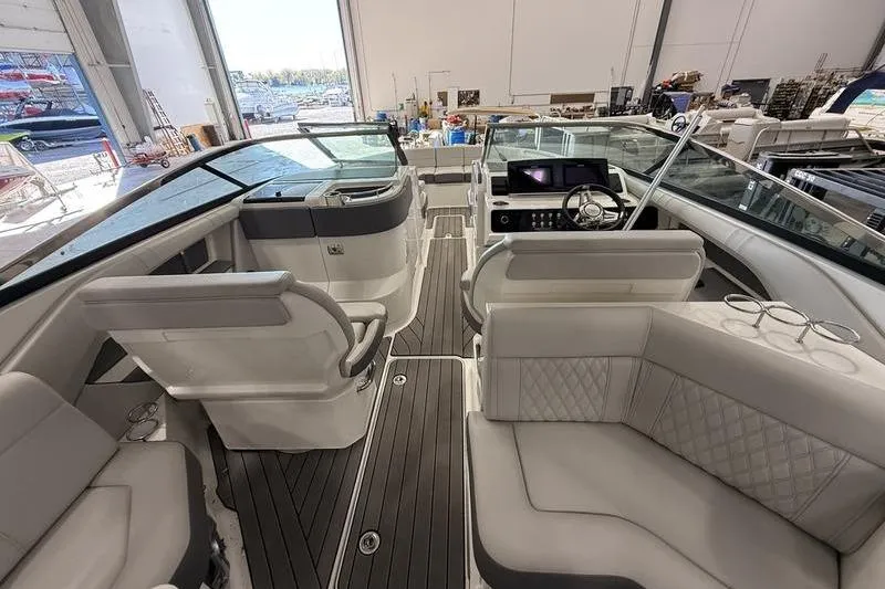 Slide: The Image of 2023 Sea Ray SLX 310 boat interior with luxurious seating and modern dashboard. - 7
