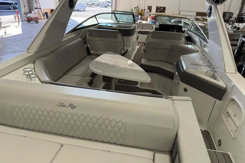 Slide: The Image of Luxurious interior of 2023 Sea Ray SLX 310 boat with elegant seating and table. - 8