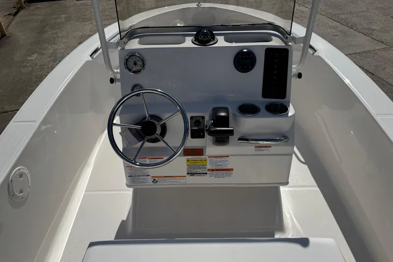 Slide: The Image of 2026 Robalo R160 Center Console boat interior with steering wheel and control panel. - 11