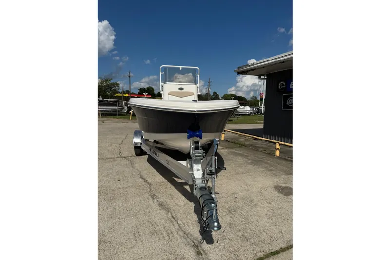 Slide: The Image of 2026 Robalo R160 Center Console boat on trailer, parked outdoors under clear sky. - 4