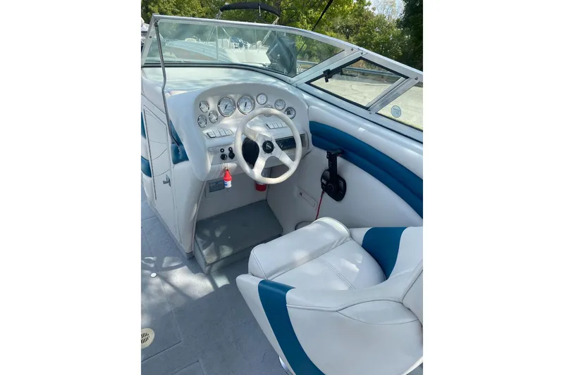 Slide: The Image of 1996 Crownline 266 BR boat interior with steering wheel and dashboard controls. - 5