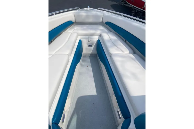 Slide: The Image of 1996 Crownline 266 BR boat interior with white and blue seating. - 7