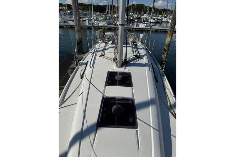 Slide: The Image of 2020 Beneteau Oceanis 30.1 sailboat docked at marina, top deck view. - 12