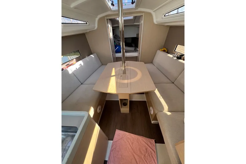 Slide: The Image of Interior of 2020 Beneteau Oceanis 30.1 sailboat with cozy seating and table. - 21