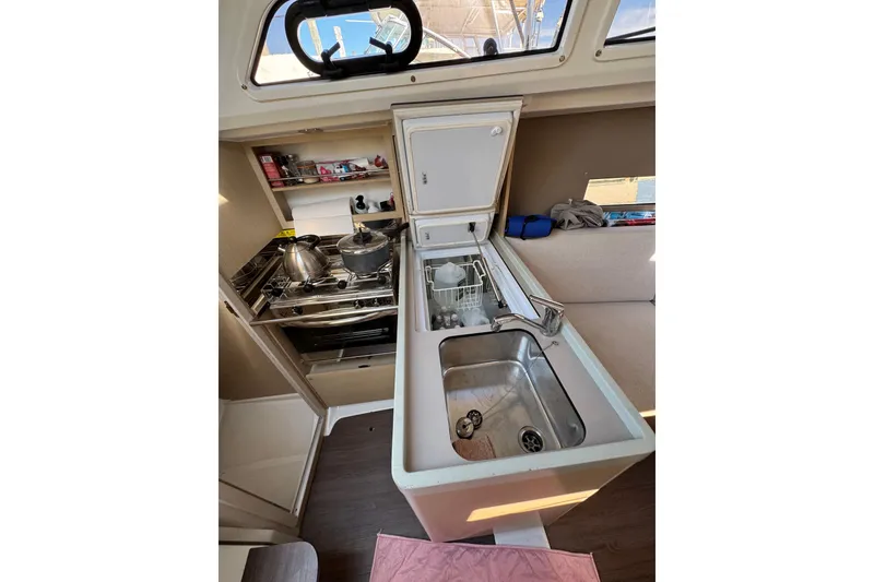 Slide: The Image of Compact kitchen in 2020 Beneteau Oceanis 30.1 yacht with stove, sink, and storage. - 23