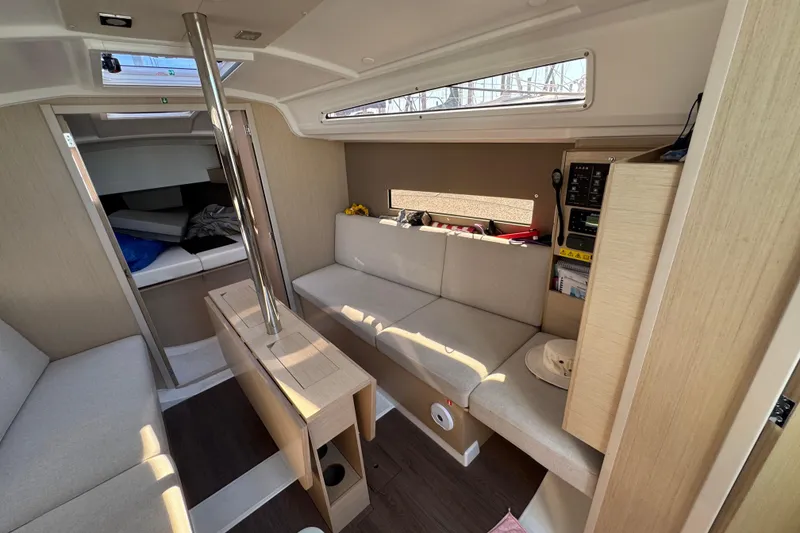 Slide: The Image of Interior of 2020 Beneteau Oceanis 30.1 yacht, featuring modern seating and wooden finishes. - 25