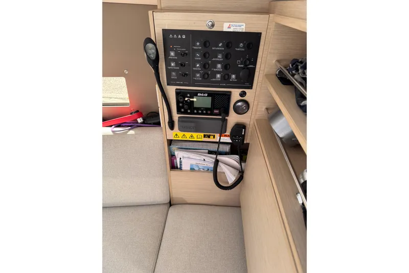 Slide: The Image of Control panel inside 2020 Beneteau Oceanis 30.1 yacht, featuring navigation and communication equipment. - 27