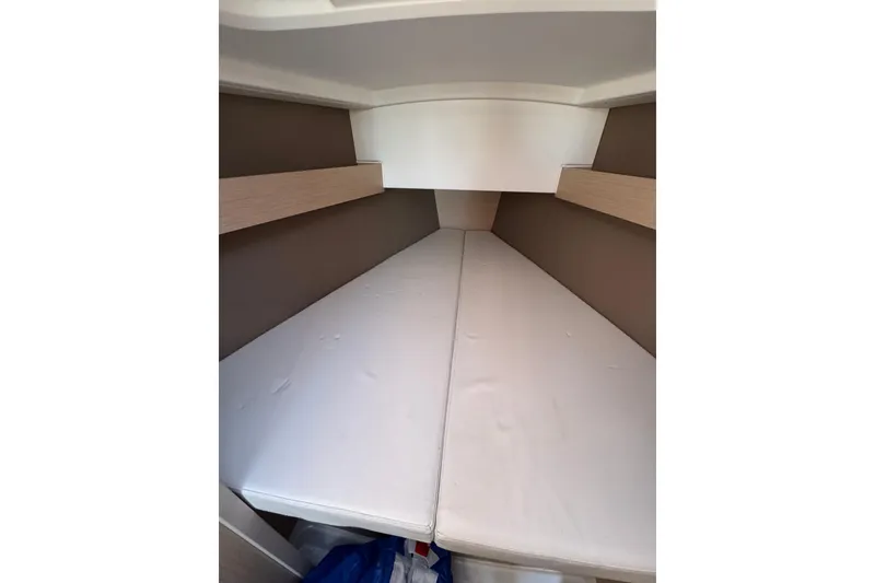 Slide: The Image of Interior cabin of 2020 Beneteau Oceanis 30.1 sailboat, featuring a cozy sleeping area. - 30