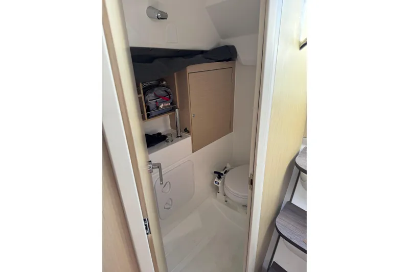 Slide: The Image of Compact bathroom in a 2020 Beneteau Oceanis 30.1 sailboat, featuring modern fixtures and storage. - 31