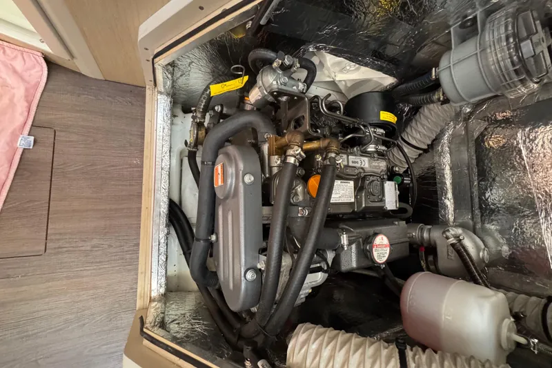 Slide: The Image of Engine compartment of a 2020 Beneteau Oceanis 30.1 sailboat, showcasing mechanical components. - 33