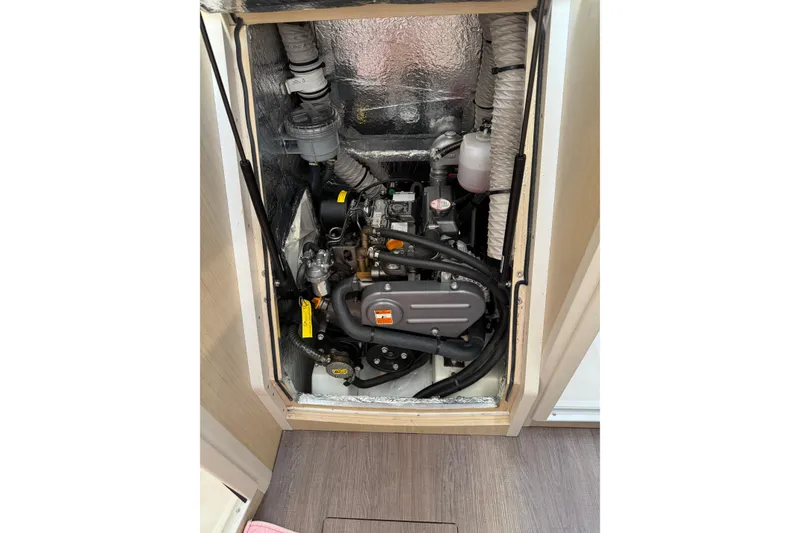 Slide: The Image of Engine compartment of 2020 Beneteau Oceanis 30.1 sailboat, showcasing mechanical components. - 35