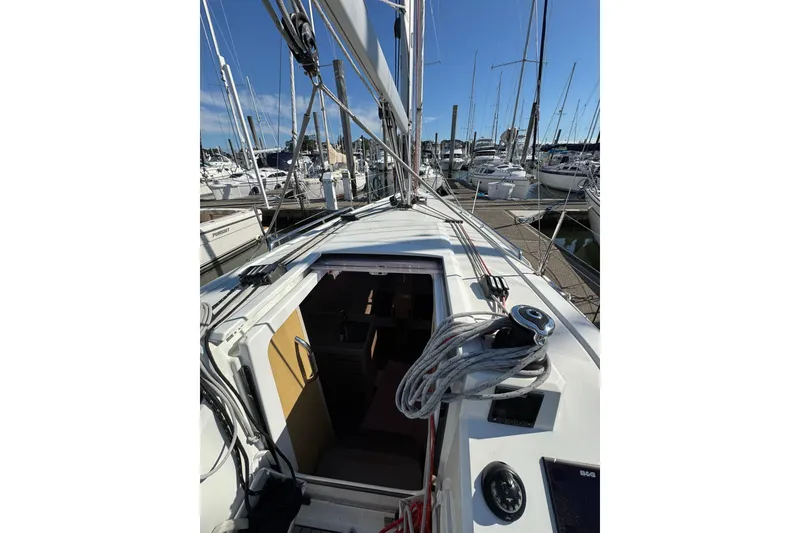 Slide: The Image of 2020 Beneteau Oceanis 30.1 sailboat docked at marina, view of deck and cabin entrance. - 7