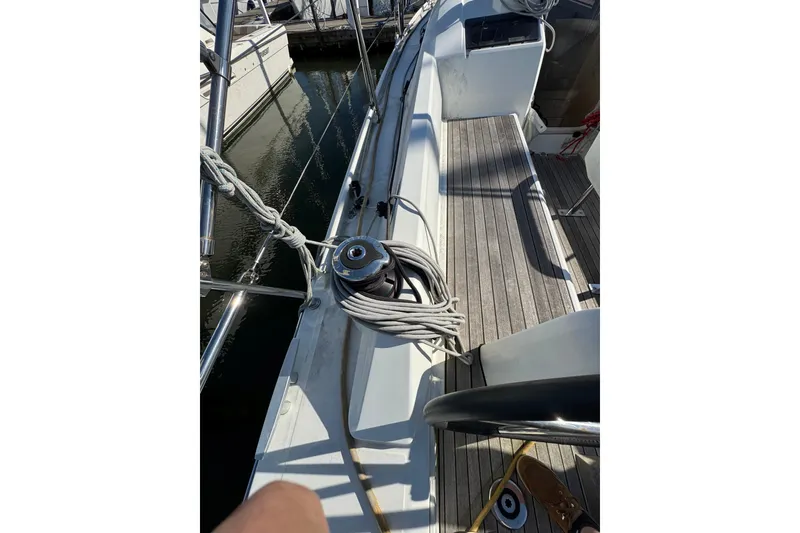 Slide: The Image of 2020 Beneteau Oceanis 30.1 sailboat deck with winch and coiled rope. - 8