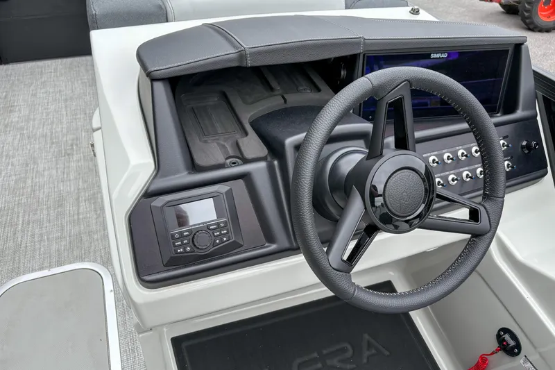 Slide: The Image of 2026 Alera M23Q boat dashboard with steering wheel and control panel. - 9
