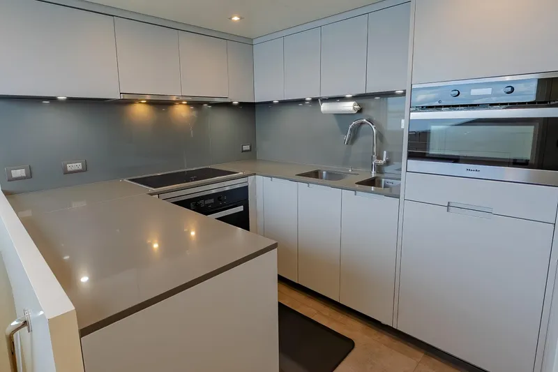 Slide: The Image of Modern kitchen in 2019 Sanlorenzo SD112 yacht with sleek cabinetry and stainless steel appliances. - 24