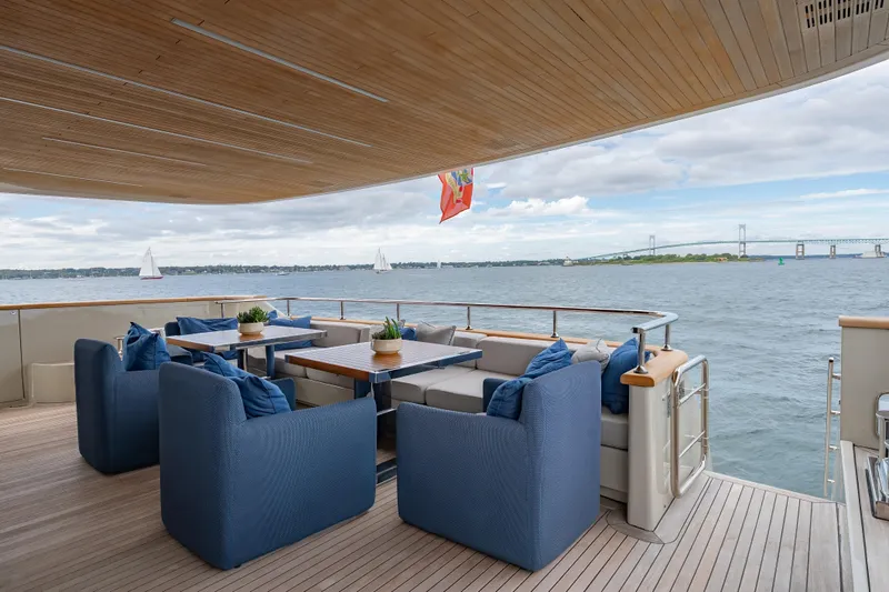 Slide: The Image of Luxurious 2019 Sanlorenzo SD112 yacht deck with elegant seating, ocean view, and bridge in background. - 9