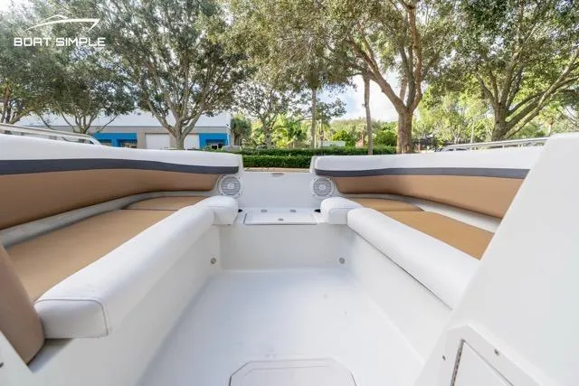 Slide: The Image of 2021 Starcraft SVX 191 OB boat interior with cushioned seating and outdoor view. - 12