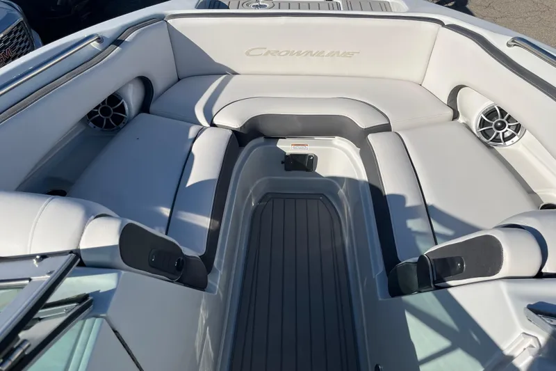 Slide: The Image of 2026 Crownline Eclipse E235 boat interior with white seating and built-in speakers. - 10