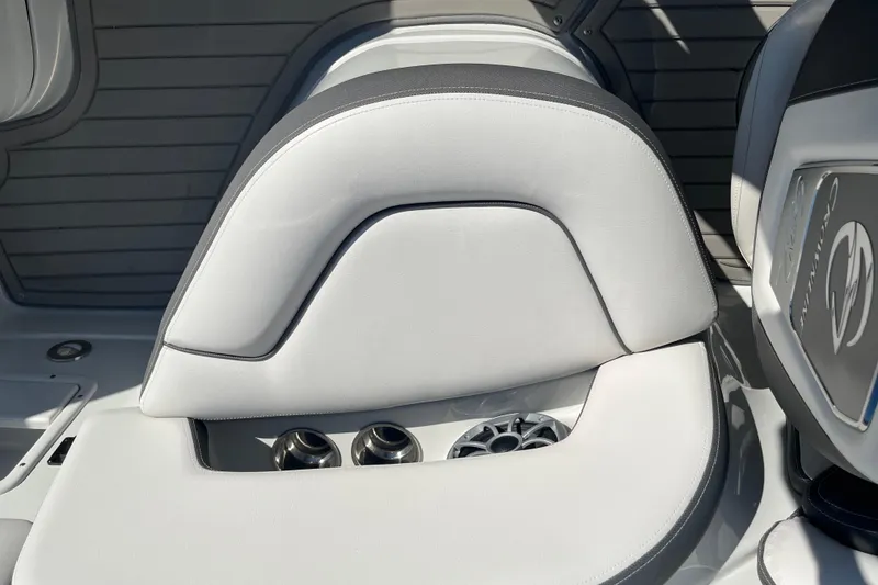 Slide: The Image of 2026 Crownline Eclipse E235 boat interior with sleek white seating and cup holders. - 11