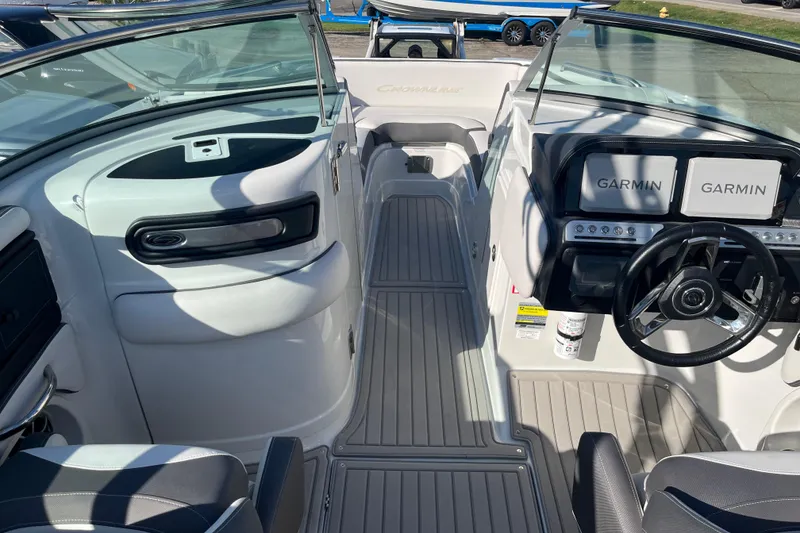 Slide: The Image of 2026 Crownline Eclipse E235 boat interior with Garmin navigation displays. - 13